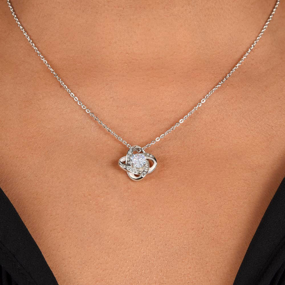 Love knot necklace worn, close-up — 14K white gold finish