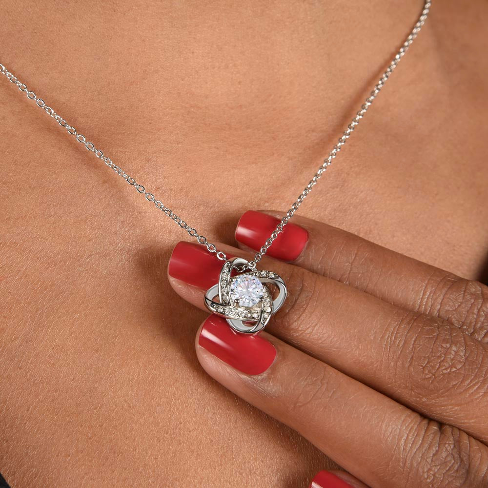 Love knot necklace worn, close-up — 14K white gold finish