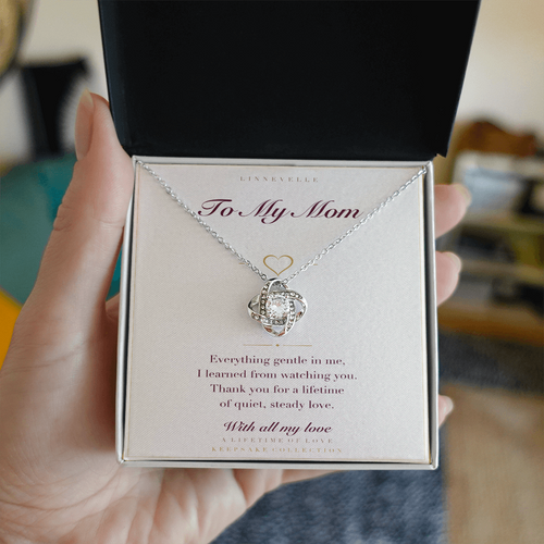 Personalized necklace with keepsake card, held in hand